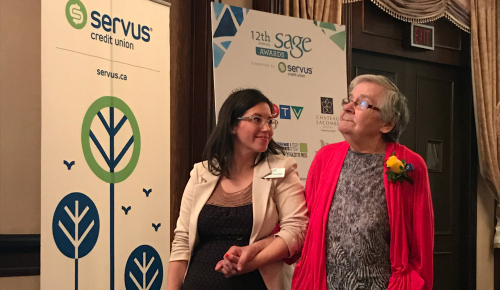 A Servus representative and a Sage Senior's Award recipient